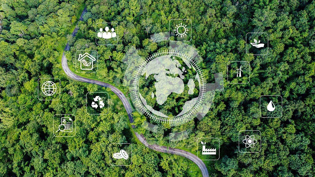 Aerial view of green forest overlayed with a large icon of earth surrounded by smaller environment icons